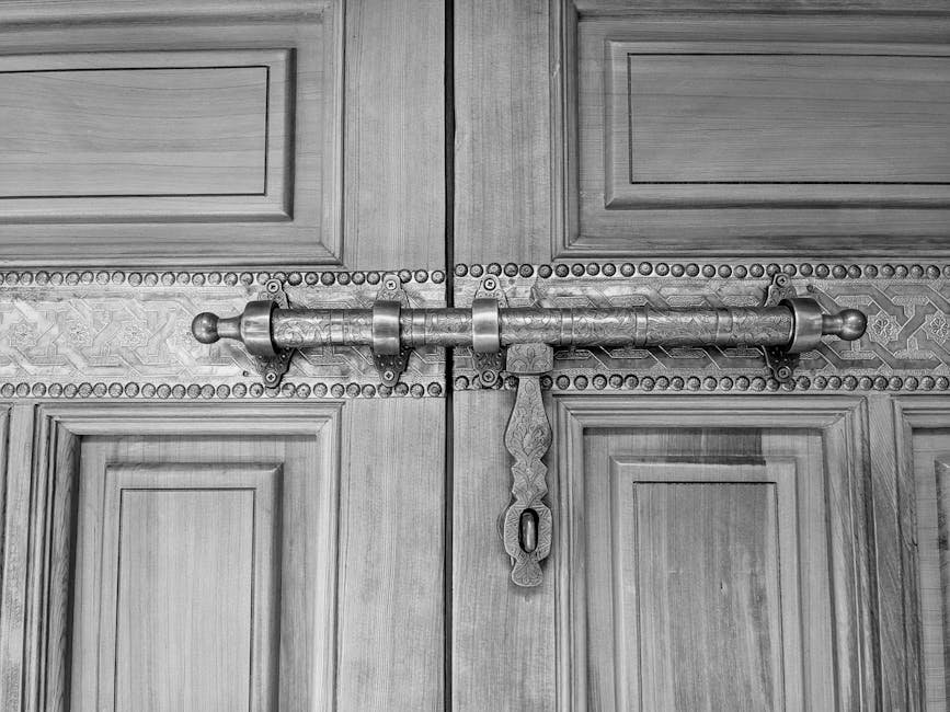 Close-up of an intricately carved wooden door with an ornate metal bolt in Morocco.