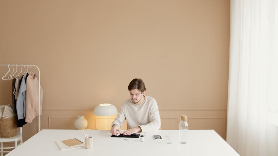 A man checks his blood glucose levels using a glucometer in a minimalist room setting.