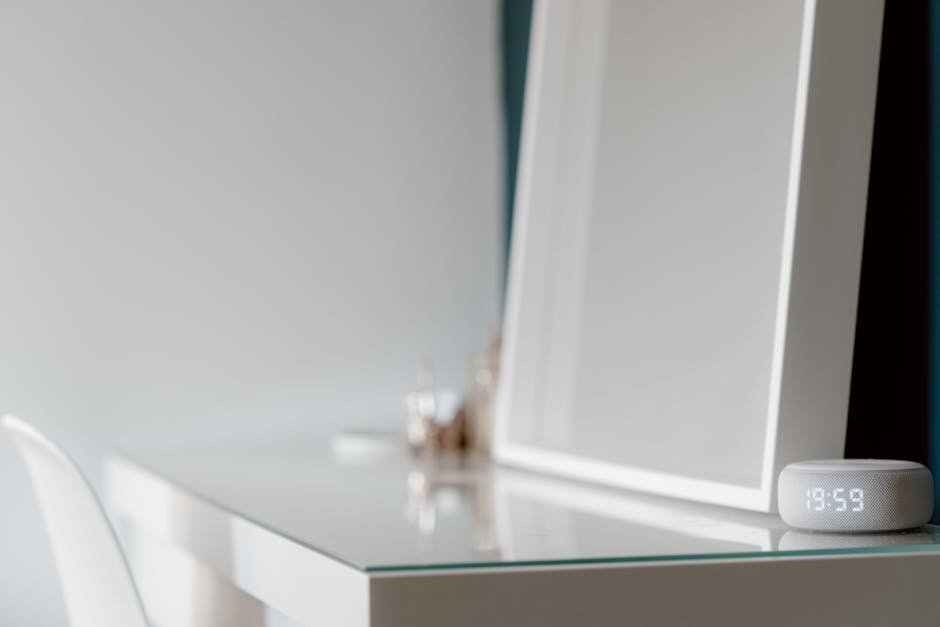 Elegant minimalist white desk setup with a digital clock in a serene setting.