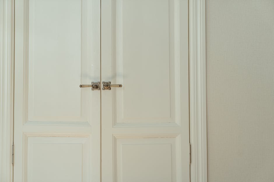 Elegant white double doors with locks, offering a stylish and secure home interior solution.