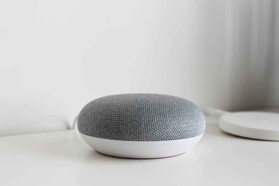 A sleek and modern smart speaker on a clean white surface, perfect for tech-inspired decor.