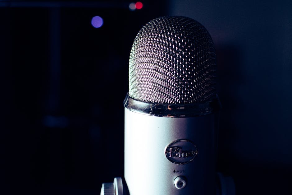 Dynamic photo of a condenser microphone in a dimly lit studio, perfect for podcasts.