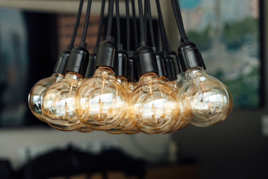 Warm glowing vintage light bulbs hanging indoors, creating an industrial and cozy ambiance.